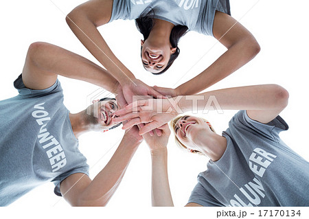 Happy volunteers putting their hands together 17170134