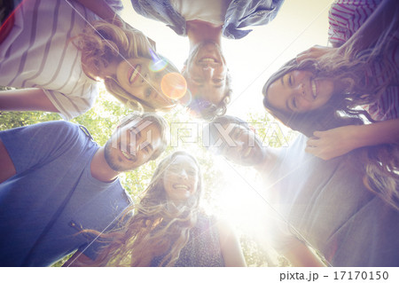 Happy friends huddling in circle in the park 17170150