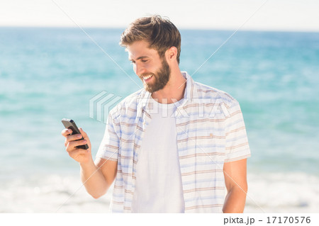 Happy man playing on his smartphone 17170576