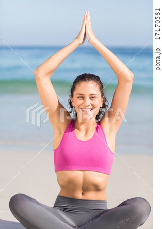 Fit woman doing yoga beside the sea Fit woman doing yoga beside the sea 17170581
