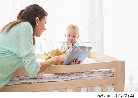 Happy mother using tablet with his baby boy Happy mother using tablet with his baby boy 17170822