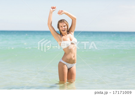 Happy pretty blonde cheering into the sea Happy pretty blonde cheering into the sea 17171009
