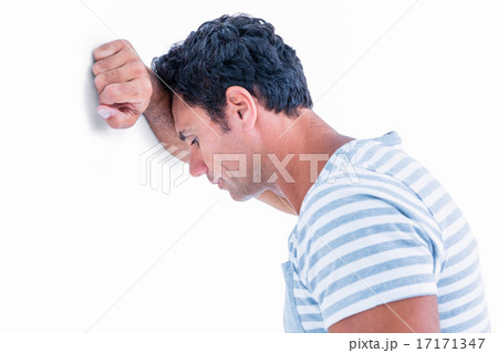 Sad man leaning his head against a wall 17171347