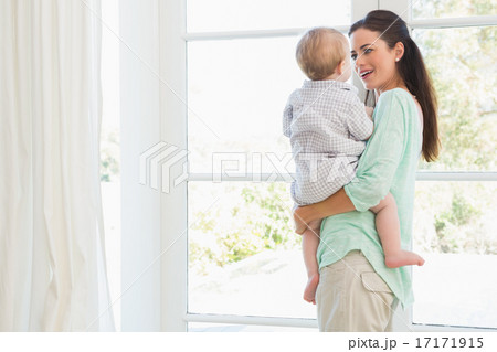 Happy mother holding baby boy 17171915