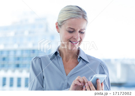 Businesswoman using her smartphone Businesswoman using her smartphone 17172002