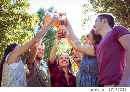 Happy friends in the park having beers 17172231