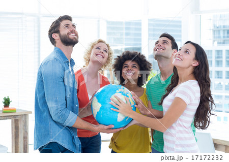 Young creative business people with a globe Young creative business people with a globe 17172232