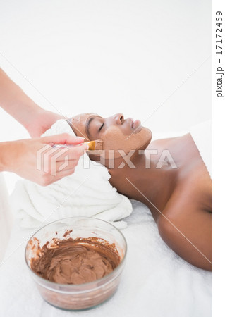 Pretty woman getting a chocolate facial treatment 17172459