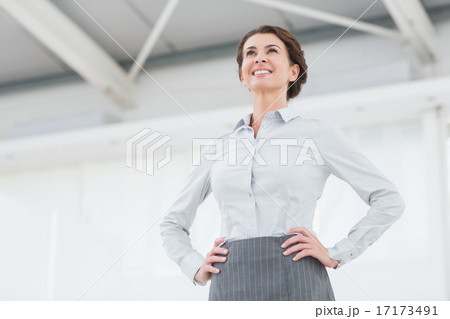 Smiling businesswoman looking away Smiling businesswoman looking away 17173491