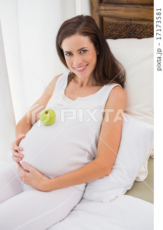 Happy pregnancy with an apple on his belly Happy pregnancy with an apple on his belly 17173581