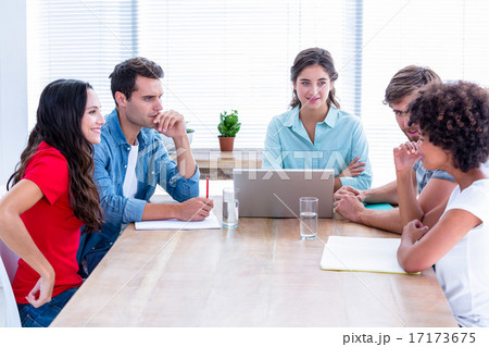 Creative business people using laptop in meeting 17173675