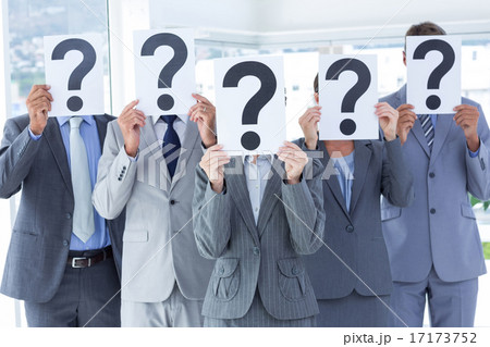 Business colleagues hiding their face with question mark sign 17173752