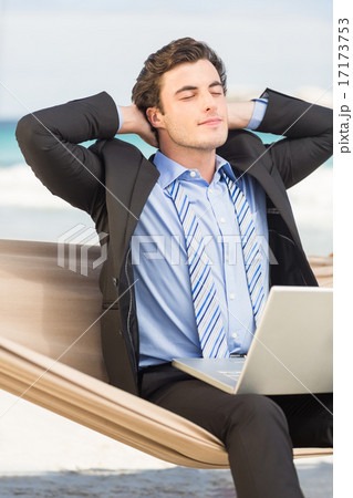 Businessman relaxing on hammock 17173753