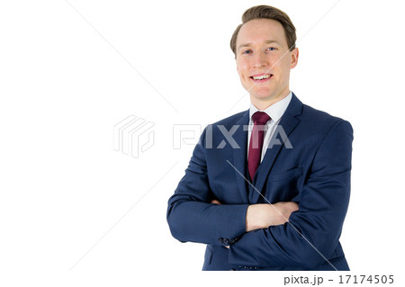 Happy businessman looking at camera with arms crossed Happy businessman looking at camera with arms crossed 17174505