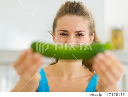 Young woman smiling with zucchini 17176136