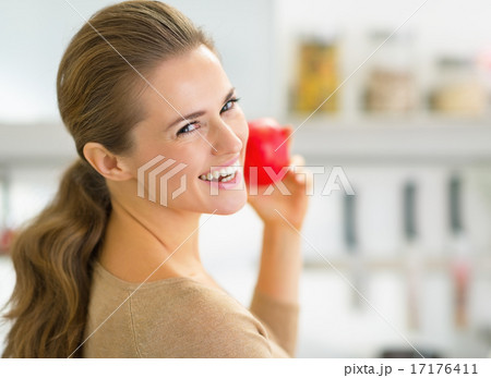 Portrait of happy young woman apple in kitchen Portrait of happy young woman apple in kitchen 17176411