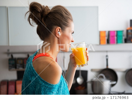 Fitness young woman drinking pumpkin smoothie in kitchen Fitness young woman drinking pumpkin smoothie in kitchen 17176963
