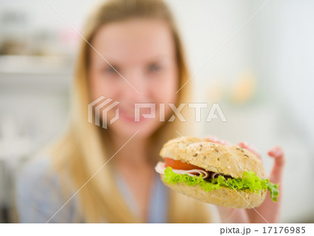 Closeup on burger in hand of teenager girl Closeup on burger in hand of teenager girl 17176985