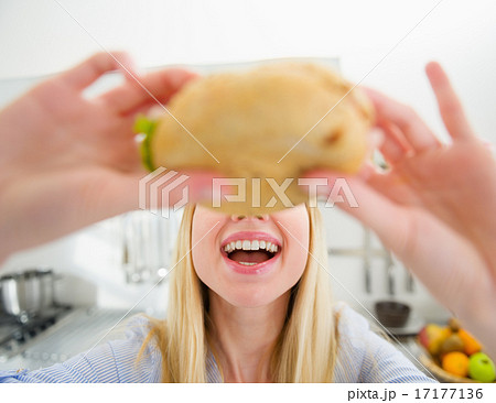 Closeup on teenager girl eating sandwich Closeup on teenager girl eating sandwich 17177136