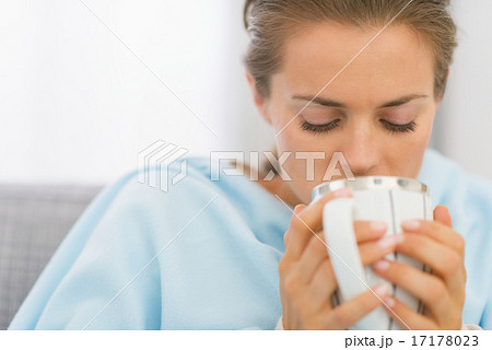 Ill young woman drinking hot beverage 17178023