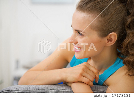 Happy young woman in living room looking on copy space 17178151