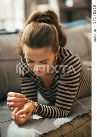 Young woman laying on divan in loft apartment 17178219