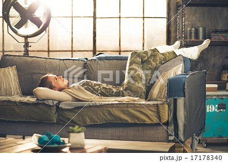 Relaxed young woman laying in loft apartment 17178340