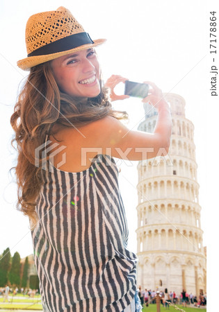 Happy young woman taking photo of leaning tower of pisa, tuscany 17178864