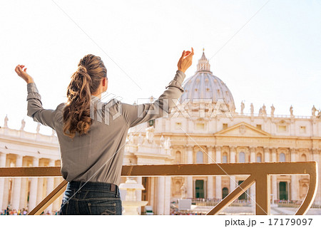 Young woman rejoicing in front of basilica di san pietro in vati Young woman rejoicing in front of basilica di san pietro in vati 17179097