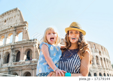 Portrait of happy mother and baby girl in front of colosseum in 17179144