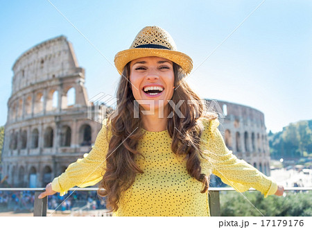Portrait of young woman in front of colosseum in rome, italy 17179176