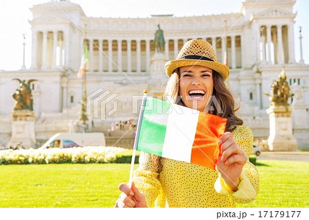 Portrait of happy young woman showing italian flag on piazza ven 17179177