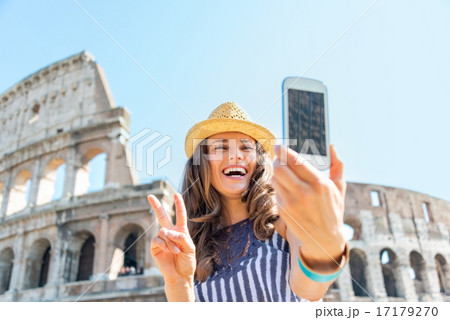 Happy young woman making selfie in front of colosseum in rome, i Happy young woman making selfie in front of colosseum in rome, i 17179270
