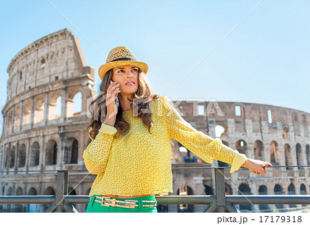 Young woman talking cell phone in front of colosseum in rome, it 17179318