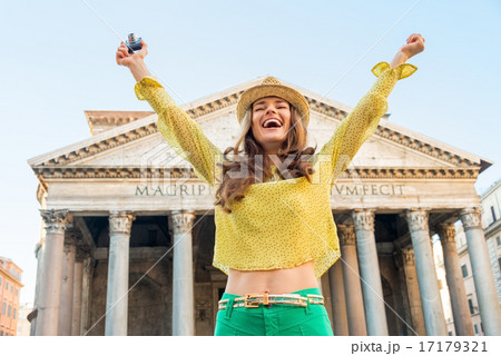 Portrait of happy young woman with photo camera rejoicing in fro 17179321