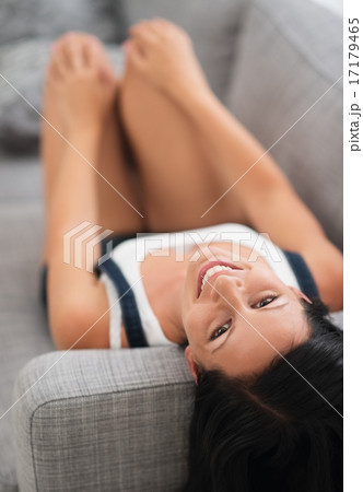 Happy girl laying on couch Happy girl laying on couch 17179465