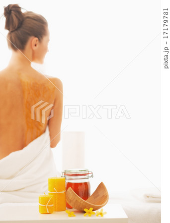 Closeup on honey spa therapy ingredients and relaxed young woman Closeup on honey spa therapy ingredients and relaxed young woman 17179781