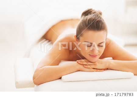 Portrait of happy young woman laying on massage table Portrait of happy young woman laying on massage table 17179783