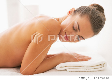 Smiling young woman laying on massage table Smiling young woman laying on massage table 17179818