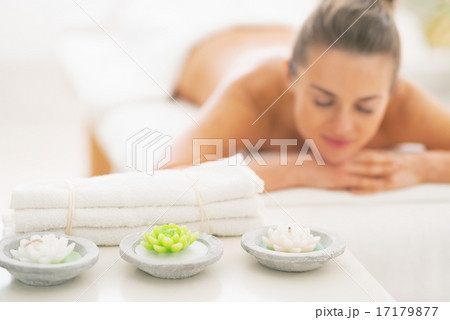 Closeup on spa elements and young woman in background Closeup on spa elements and young woman in background 17179877