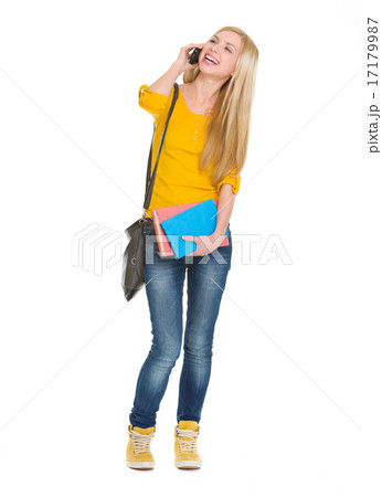 Full length portrait of smiling student girl talking mobile phon Full length portrait of smiling student girl talking mobile phon 17179987