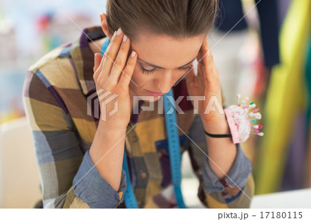 Portrait of stressed tailor woman at work Portrait of stressed tailor woman at work 17180115