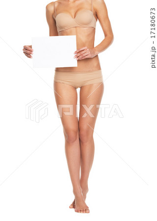 Closeup on young woman in lingerie showing blank paper sheet 17180673