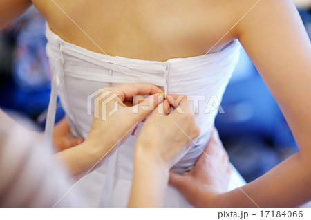 Helping the bride to put her wedding dress on Helping the bride to put her wedding dress on 17184066