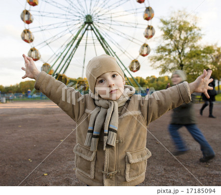 little cute boy outside in park near carousel gesturing little cute boy outside in park near carousel gesturing 17185094