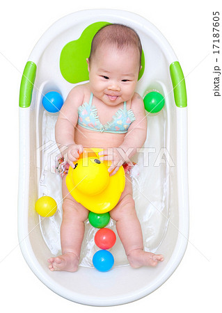 Asian baby girl taking a bath in white tub and playing duck 17187605
