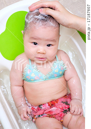 Mom washing baby girl hair 17187607