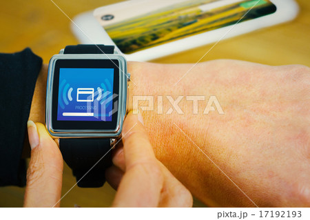 Composite image of businesswoman with smart watch on wrist 17192193