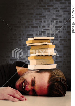 Composite image of stressed businessman banging his head 17192285