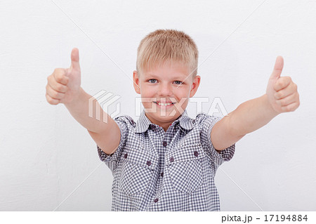 Portrait of happy boy showing thumbs up gesture 17194884